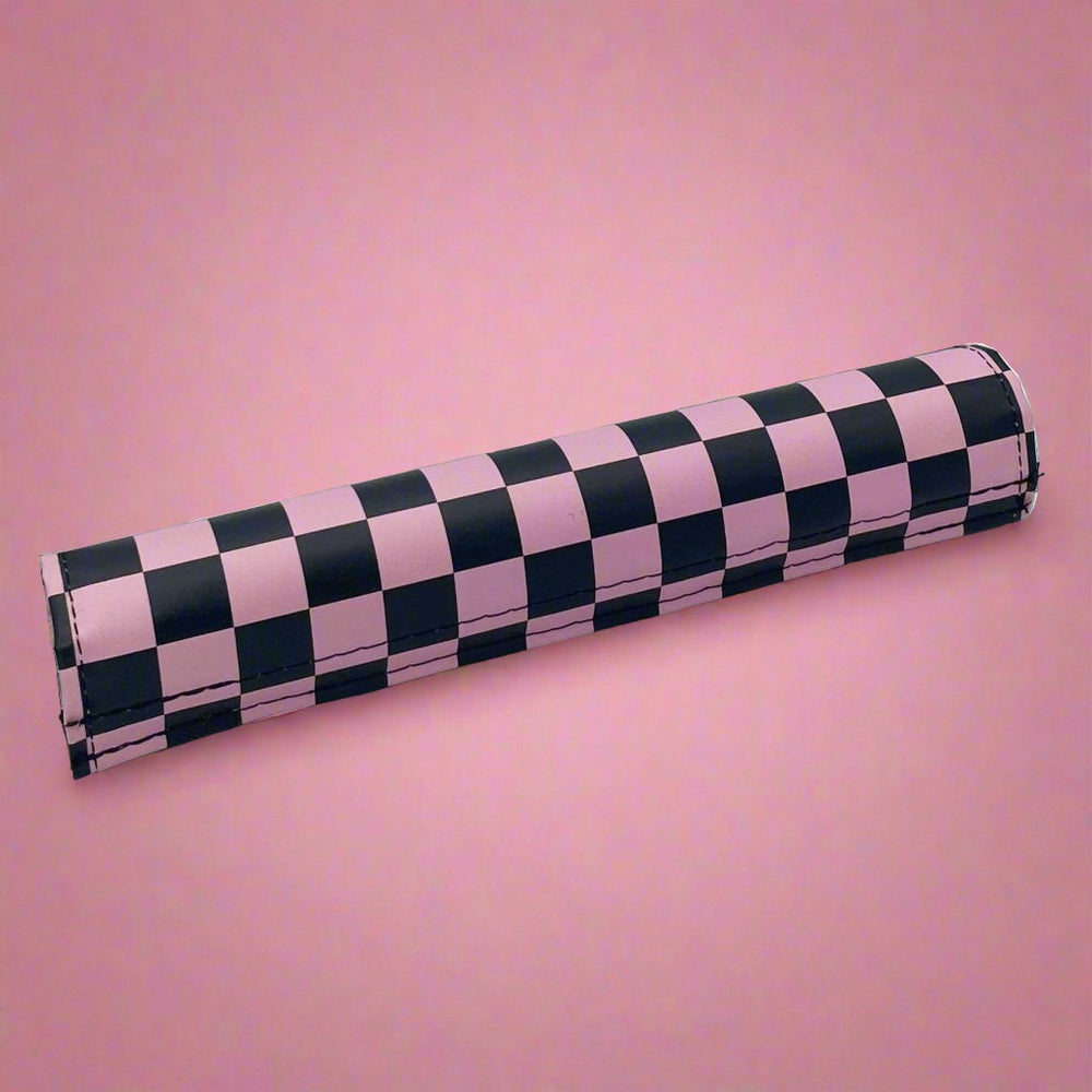 pink and black checkered bar pad